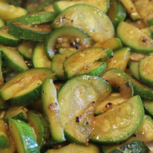 A big platter is full of sauteed zucchini glazed with a simple Asian Hoisin sauce glaze.