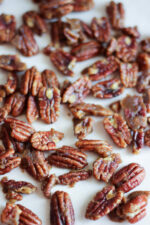 A trey of lightly candied pecans scattered on it. The pecans have just a touch of brown sugar and are lightly sweet and crunchy.