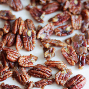 A trey of lightly candied pecans scattered on it. The pecans have just a touch of brown sugar and are lightly sweet and crunchy.