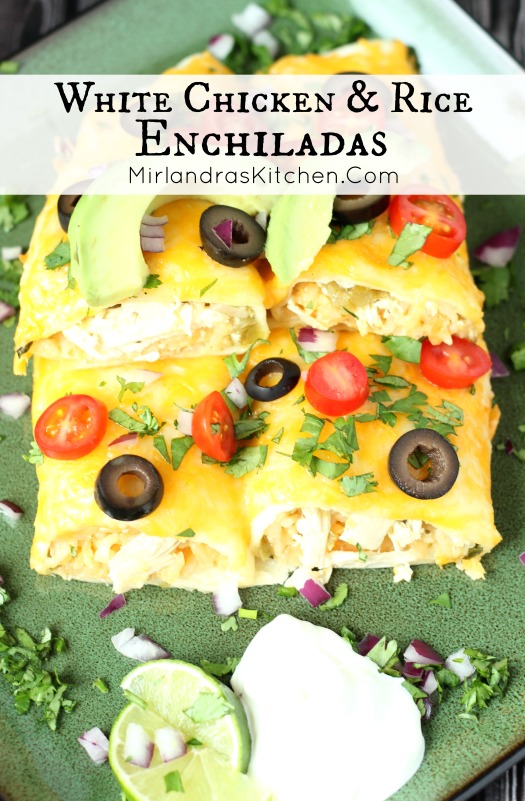A green plate has four enchiladas stacked on it. They are garnished with olives, tomatoes and cilantro.
