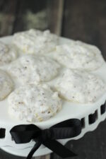 A white dessert platter is covered with forgotten cookies. Each cookie looks like a white pillow.