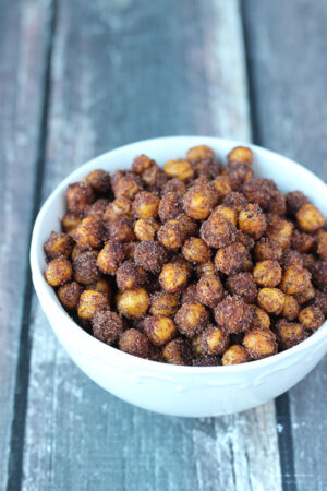 Cinnamon roasted chick peas in a bowl. This is a easy, healthy snack that is fast to bake in the oven.