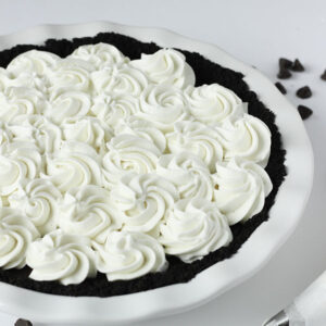 This chocolate cream pie is decorated with homemade whipped cream. The cream is piped on with lovely swirls.