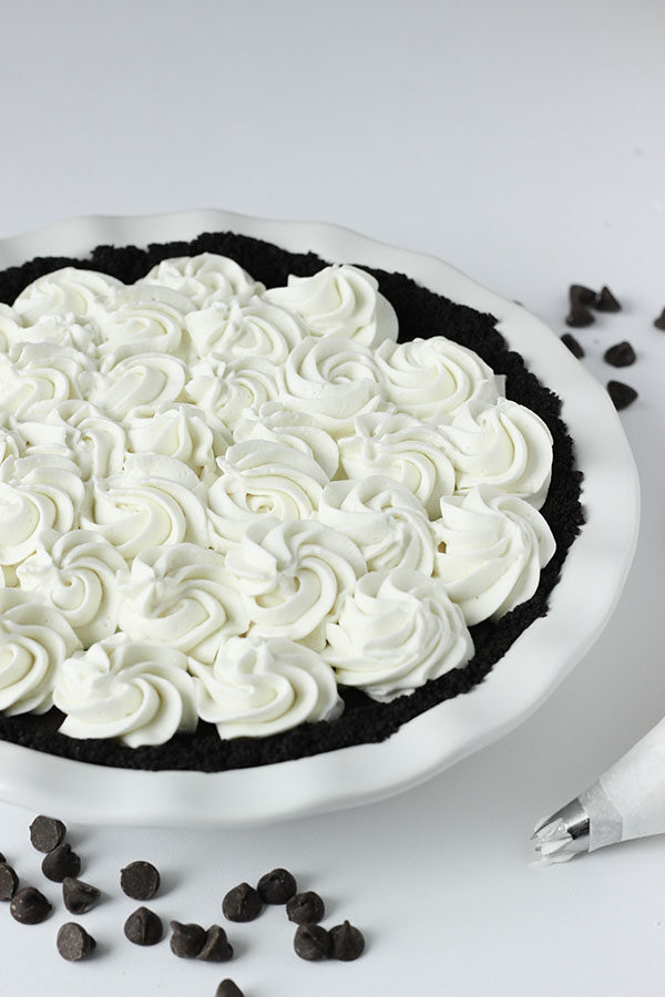 This chocolate cream pie is decorated with homemade whipped cream. The cream is piped on with lovely swirls.