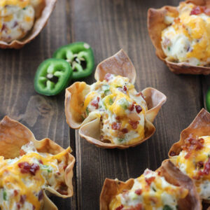 Darling baked wonton wrappers are the perfect crunchy bowls to hold cheesy cream cheese and bacon jalapeno filling!