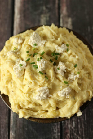 Beautiful golden mashed potatoes topped with Boursin Cheese and fresh chives. These potatoes are wonderful for a holiday meal or everyday dinner.