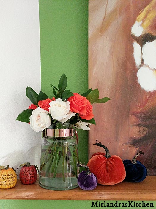 Beautiful debi lilly design roses in a debi lilly vase with debi lilly velvet pumpkins on my mantle. This is a simple fall decoration set up for my fireplace.