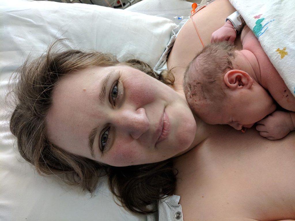 Mirlandra holding baby Ella in the NICU at several hours old.