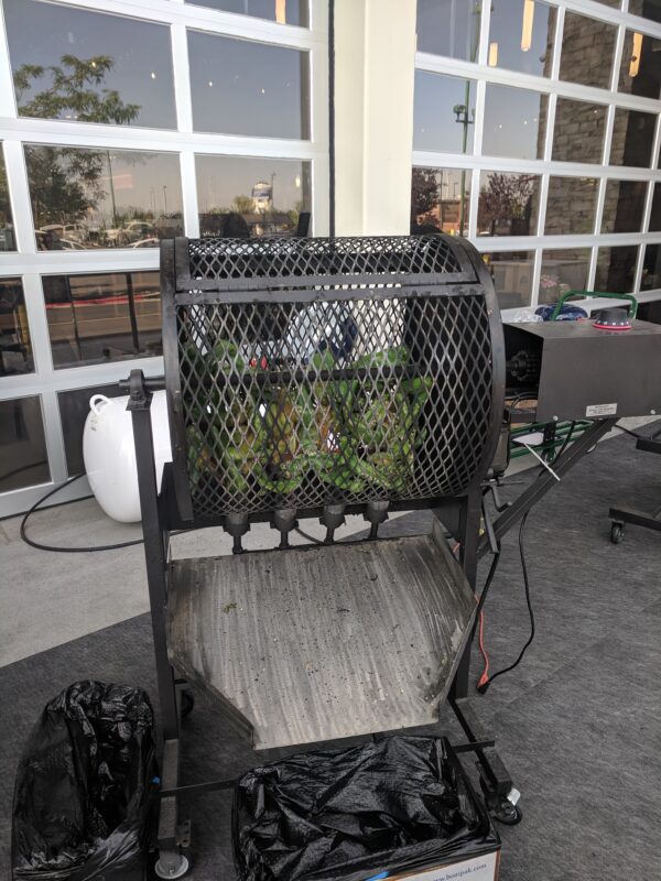Hatch Chile peppers being roasted in Boise, Idaho at Market St. Albertsons.  The roasting wheel turns automatically while propane fire perfectly blisters the peppers. 