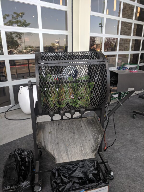 Hatch Chile peppers being roasted in Boise, Idaho at Market St. Albertsons. The roasting wheel turns automatically while propane fire perfectly blisters the peppers.