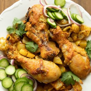 Tender chicken roasted up with cauliflower, squash, potatoes and onions. Here it is pictured with a lemon, cucumber and onion pickled salad.