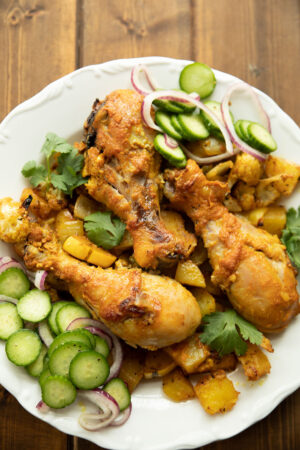 Tender chicken roasted up with cauliflower, squash, potatoes and onions. Here it is pictured with a lemon, cucumber and onion pickled salad.