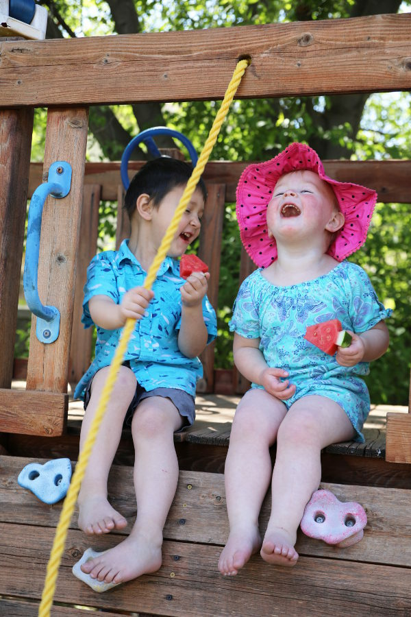 Jack and Ella laughing and eating their watermelon. 