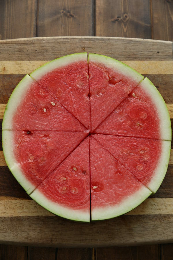 A slice of watermelon cut into 8 triangles.  