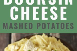 this is a Pinterest promo image featuring a Boursin Cheese Recipe.  There is a bowl of mashed potatoes garnished with chunks of Boursin Cheese and some fresh chives.  The writing on the image says Boursin Cheese Mashed Potatoes.