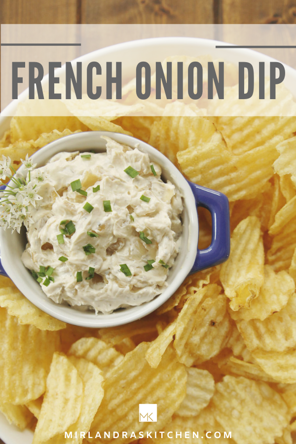 French Onion Dip image for pinterest. There is a bowl of potato chips and a blue dish of French onion dip garnished with chives and chive flowers. 