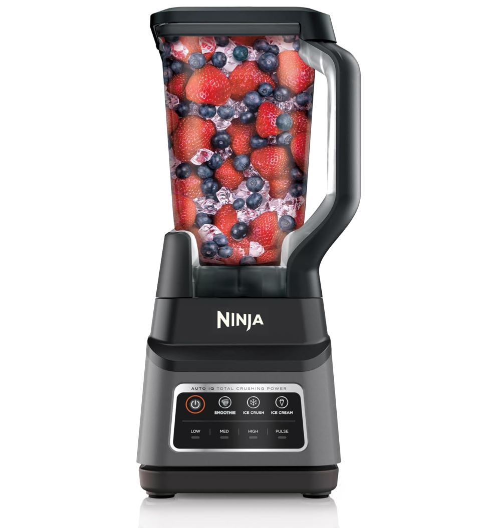 ninja blender full of strawberries, blueberries, and ice