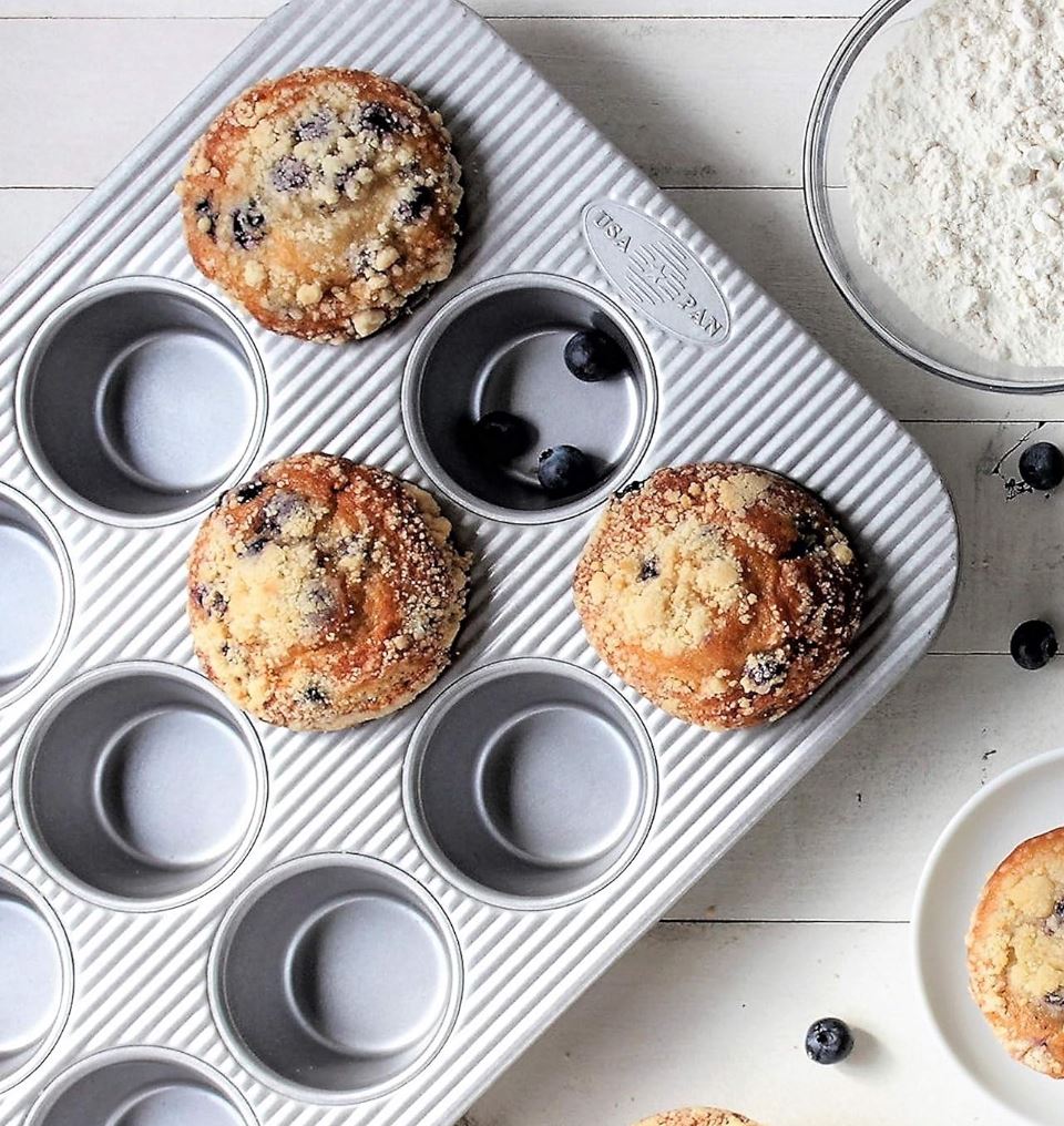 usa bakeware muffin tin with blueberry muffins in it