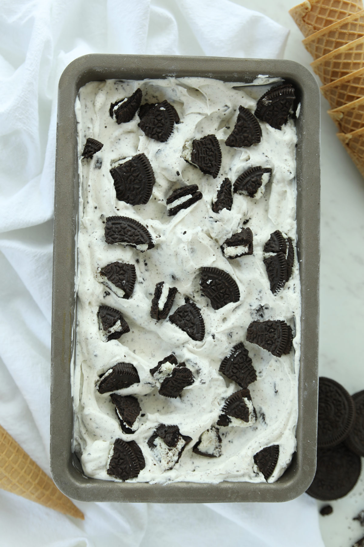 Unscooped no-churn cookies and cream ice cream fresh from the freezer, studded with whole and broken Oreo pieces