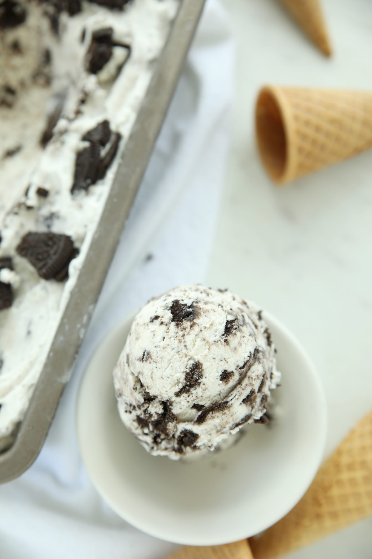 Close-up of a single scoop of cookies and cream ice cream showing creamy texture and visible cookie pieces